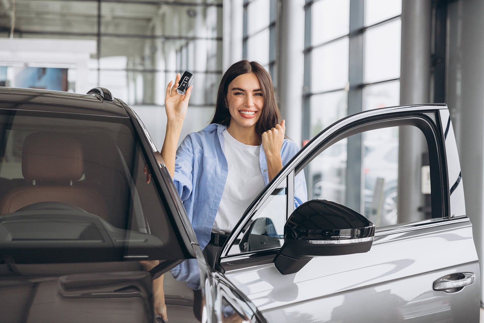 Happy first-time car buyer holding keys